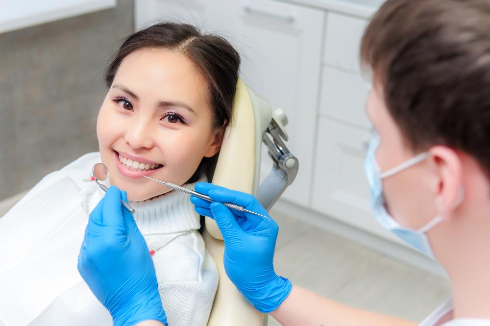 A smiling woman getting an evaluation for braces in raymond terrace