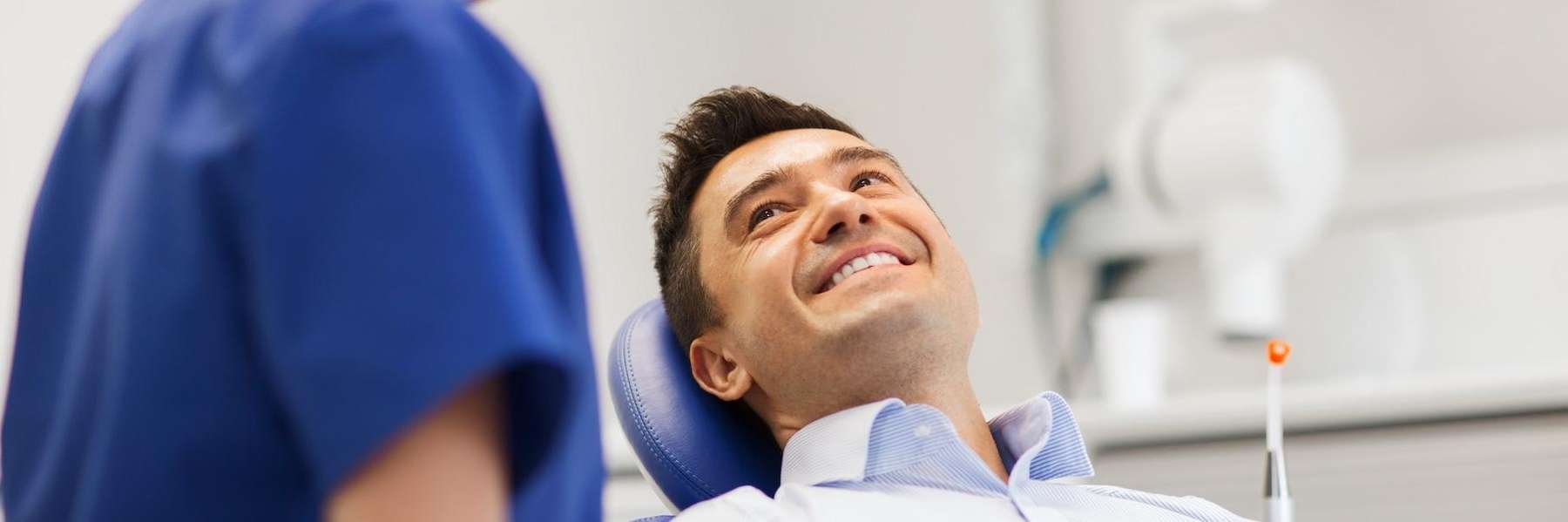 A smiling man speaking to his dentist | dentist Raymond Terrace
