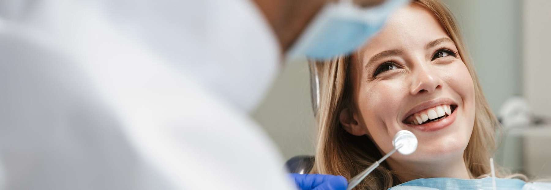 A smiling woman getting a dental exam