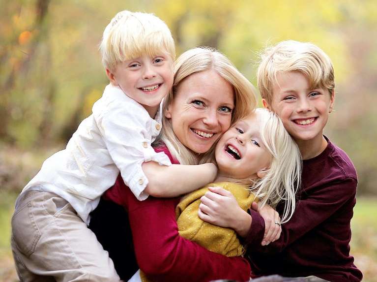 A laughing family in the forest | dentist Kurri Kurri