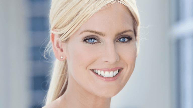 A smiling woman outdoors | dentist Raymond Terrace NSW