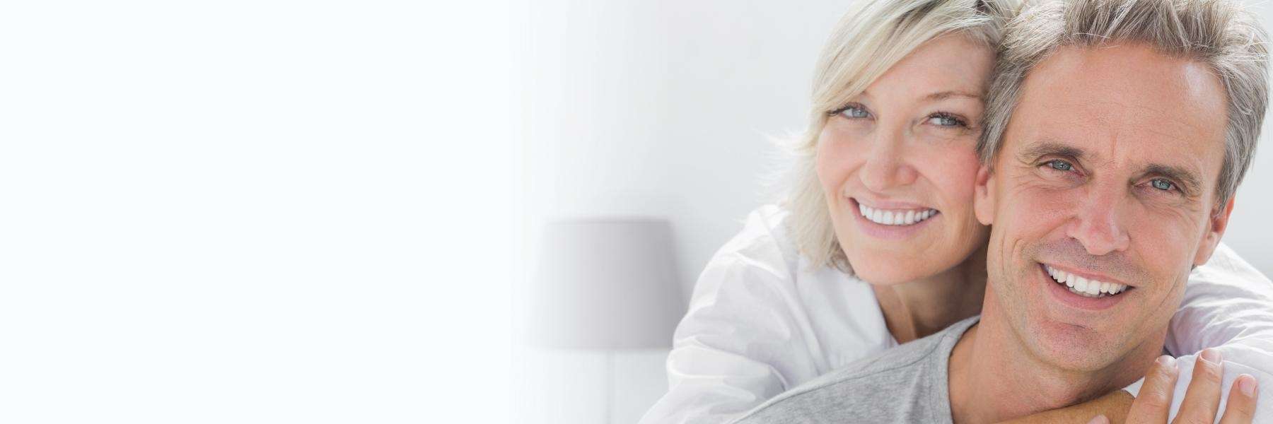 A smiling couple in the living room | dentist 2324