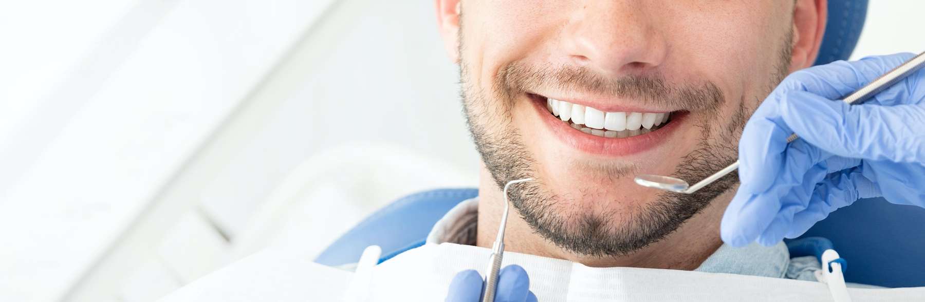 A smiling man getting a dental exam