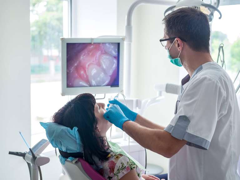 A dentist using an intraoral camera